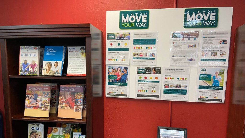 bookcase with health resources next to posterboard with how to stay active